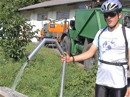 Luke at the very welcome water fountain at a farm near Penthalaz, 44.4 miles into the ride